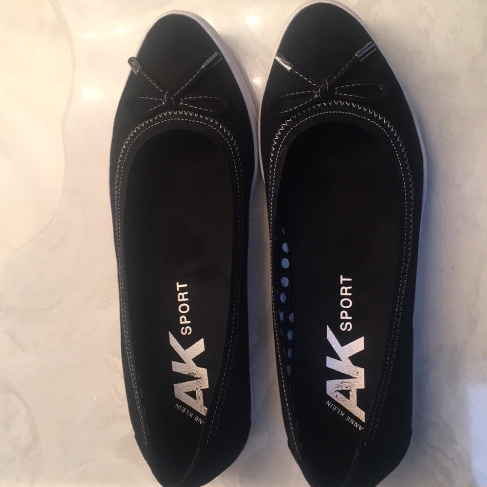 Black suede slip-ons with white rubber soles.
